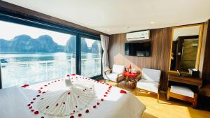 a bedroom with a bed with red hearts on it at UniCharm Cruise in Ha Long