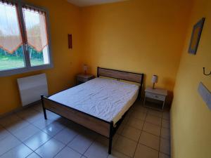 a bedroom with a bed and two night stands at Maison de plain-pied avec jardin clôturé, proche Thermes St Roch - 3 chambres, WiFi, cuisine équipée - FR-1-541-46 in La Roche-Posay