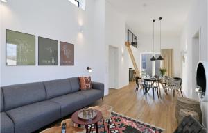 a living room with a couch and a table at Lovely Home In Lembruchdümmer See in Lembruch