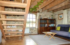 a living room with a blue couch and a book shelf at Beautiful Home In Loisia With Wifi 