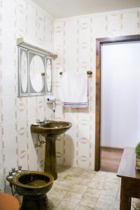 a bathroom with a sink and a toilet at Casa Di Mattoni in Bento Gonçalves