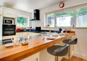 a kitchen with a wooden counter top in a room at The Lodge in Pwllheli