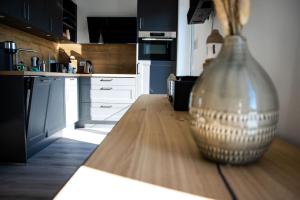 a vase sitting on top of a wooden table in a kitchen at Ferienhaus "Q" - Wohnung 3 in Zingst