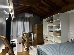 a bedroom with a bed and a book shelf at Moradas Desterro, próximo ao aeroporto 23 in Florianópolis