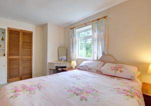 a bedroom with a bed and a window at Ty Dulas in Esgair-geiliog