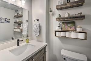 a bathroom with a sink and a toilet and a mirror at Lakefront Family Retreat Skiing and Mountain Biking in Greenwood +37 photos