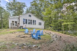 a house with blue chairs in front of it at Family-Friendly Greenwood Home with Lake Access in Greenwood