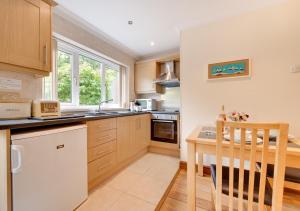 a kitchen with a table and a dining room at Hallstatt in Saundersfoot