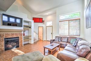 a living room with a couch and a fireplace at Cave Creek Retreat with Private Pool and Hot Tub! in Cave Creek