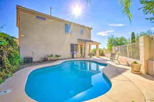 a swimming pool in front of a house at Cave Creek Retreat with Private Pool and Hot Tub! in Cave Creek