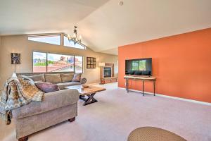 a living room with a couch and a tv at Scenic Sedona Duplex - Cathedral Rock Views! in Sedona