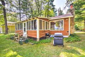 a tiny house with a grill in a yard at Crivitz Lakefront Escape with Boat Dock and Slip! in Crivitz