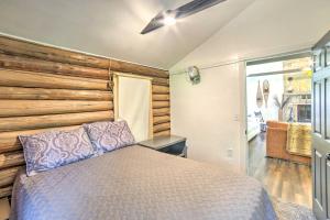a bedroom with a bed and a wooden wall at Crivitz Lakefront Escape with Boat Dock and Slip! in Crivitz