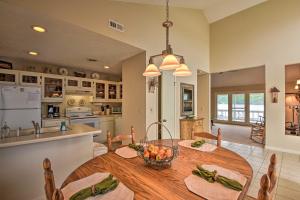a kitchen and dining room with a large wooden table at Fire Pit and Boat Dock Lake Chatuge Townhome! in Hiawassee