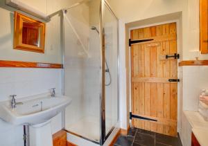a bathroom with a sink and a shower at Ty Eiddew in Caernarfon