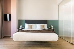 1 dormitorio con 1 cama grande y 2 mesitas de noche en Open Hotel, en Rímini