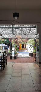 a patio with a table and chairs in a building at HOTEL OLIVIA in Mina Clavero