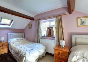 a bedroom with two beds and a window at Gors in Llanfair Caereinion