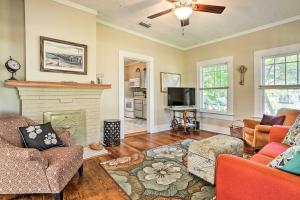 a living room with two couches and a fireplace at Moon Pie Cottage Near Dtwn Ocean Springs! in Ocean Springs