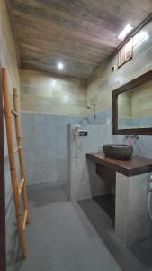 a bathroom with a sink and a mirror at Samba Villas Beachfront View in Gili Trawangan