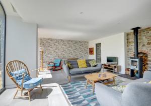 a living room with a couch and a table at The Coach House in Bottwnog