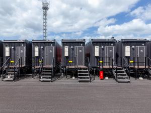 a row of portable toilets in a parking lot at HOTEL R9 The Yard Buzen in Buzen