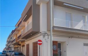 a building with a red stop sign in front of it at 1 Bedroom Nice Apartment In Pozzallo in Pozzallo