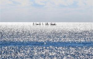 a group of sailboats in the ocean on the water at 1 Bedroom Nice Apartment In Pozzallo in Pozzallo