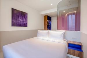 Postel nebo postele na pokoji v ubytování Wink Hotel Saigon Centre - 24hrs Lifestyle Stay
