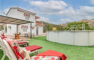 a backyard with a green lawn with chairs and a playground at 3 Bedroom Gorgeous Home In Malaga in Málaga +30 photos