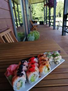 a plate of sushi sitting on a table at Putraimi. in Princmuiza