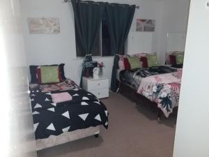 a bedroom with two beds and a window at The DOLPHIN PLACE in Australind