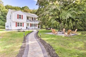 a brick walkway in front of a white house at Upscale Waterbury Retreat with Indoor Hot Tub! in Waterbury