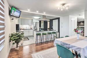 a kitchen and living room with a table and chairs at Upscale Waterbury Retreat with Indoor Hot Tub! in Waterbury