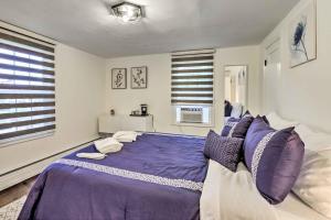 a bedroom with a large purple bed with pillows at Upscale Waterbury Retreat with Indoor Hot Tub! in Waterbury