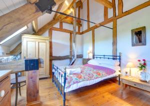 a bedroom with a bed in a room with wooden ceilings at Threshing Barn in Llansawel