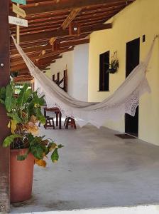 a room with a hammock in a building at Alameda dos Coqueirais in Icaraí