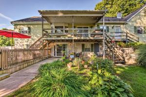 a house with a deck and an umbrella at New Holland Apartment with Patio, Deck and Pool in New Holland