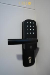 a black wall mounted remote control on a wall at Hotel Credo in Prizren