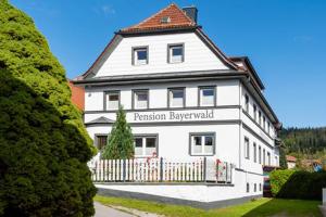 a large white building with a red roof at Pension Bayerwald in Bodenmais