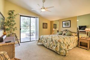 a bedroom with a bed and a ceiling fan at Cathedral City Golf Course Condo with Patio in Cathedral City