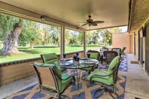 a screened porch with a table and chairs at Cathedral City Golf Course Condo with Patio in Cathedral City