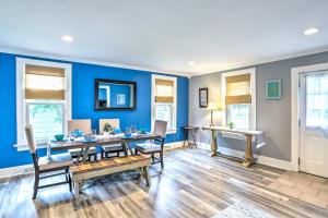 a dining room with blue walls and a table and chairs at Sweetwater Hideaway - Blocks to Lake Erie! in Port Clinton