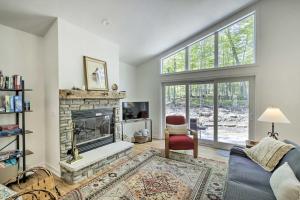 a living room with a fireplace and a chair at Door County Family Home 3 Mi Whitefish Dunes in Sturgeon Bay