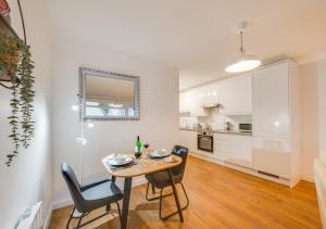 a kitchen and dining room with a table and chairs at Woodridge Court in Newton