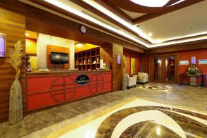 a lobby of a hotel with a bar and a tv at Crystal De Luxe Resort & Spa - All Inclusive in Kemer