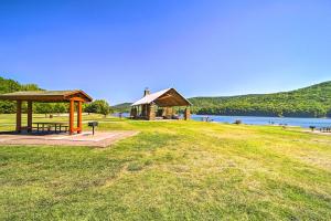 a picnic shelter in a field next to a lake at Mountainburg Apt Less Than 5 Mi to Lake Fort Smith! in Chester