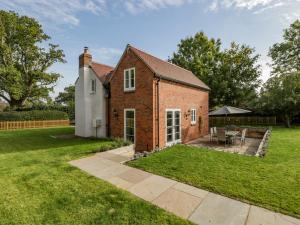 a brick house with a patio in the yard at Number 29 in Malvern Link