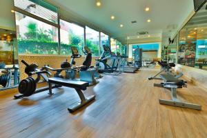 a gym with a row of treadmills and exercise bikes at Crystal Aura Beach Resort & Spa - Ultimate All Inclusive in Kemer