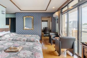 a bedroom with two beds and a desk and a chair at Residence Ferie Nara station in Nara